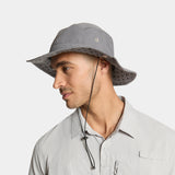 Man wearing a gray bucket hat on a light gray background