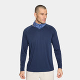 Blue paisley patterned Cooling Neck Gaiter with a Mission logo on a male model with a white background