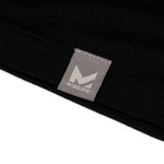 Close-up of a black garment with a gray 'Mission' brand label.