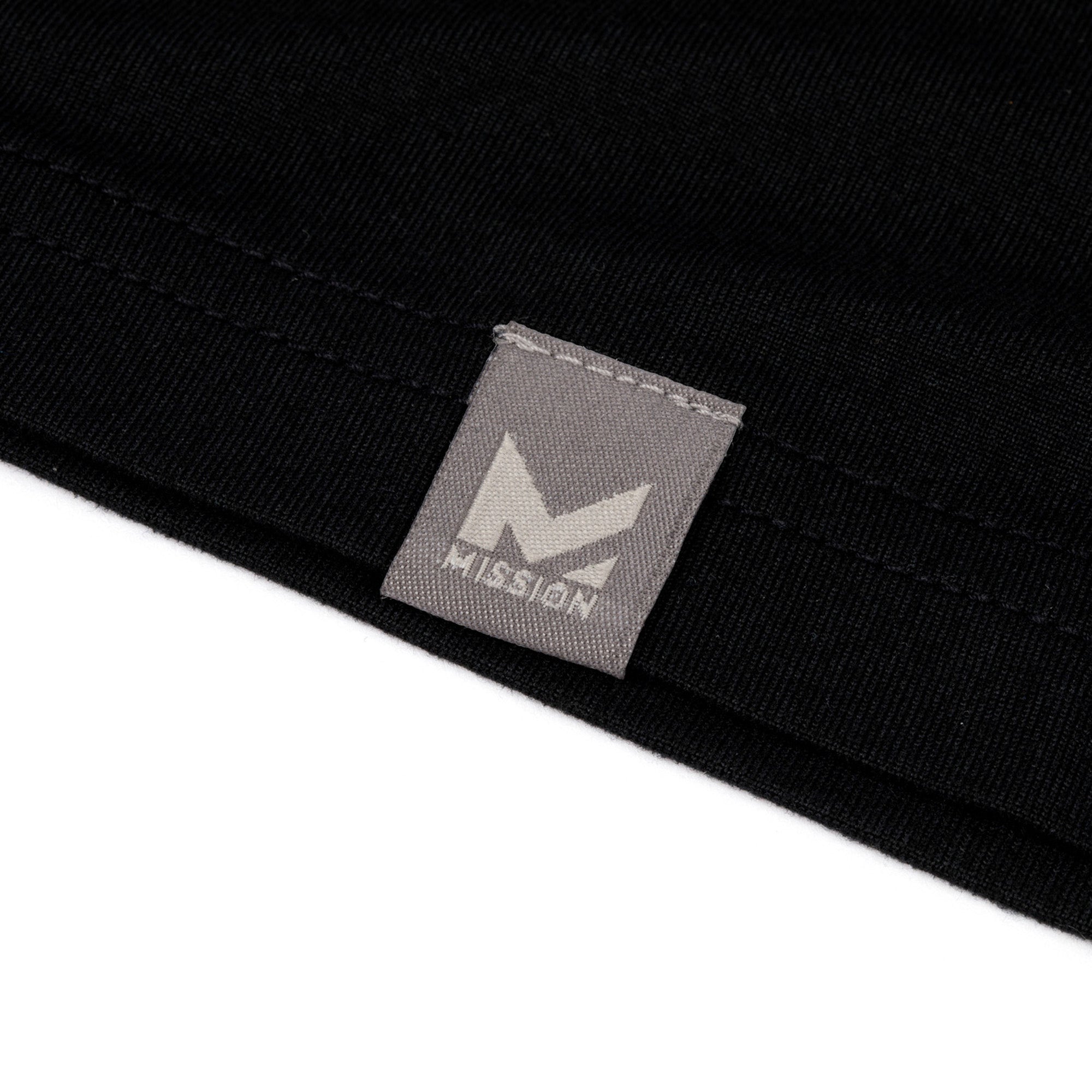 Close-up of a black garment with a gray 'Mission' brand label.
