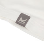 Close-up of a gray tag with 'Mission' logo on a white background