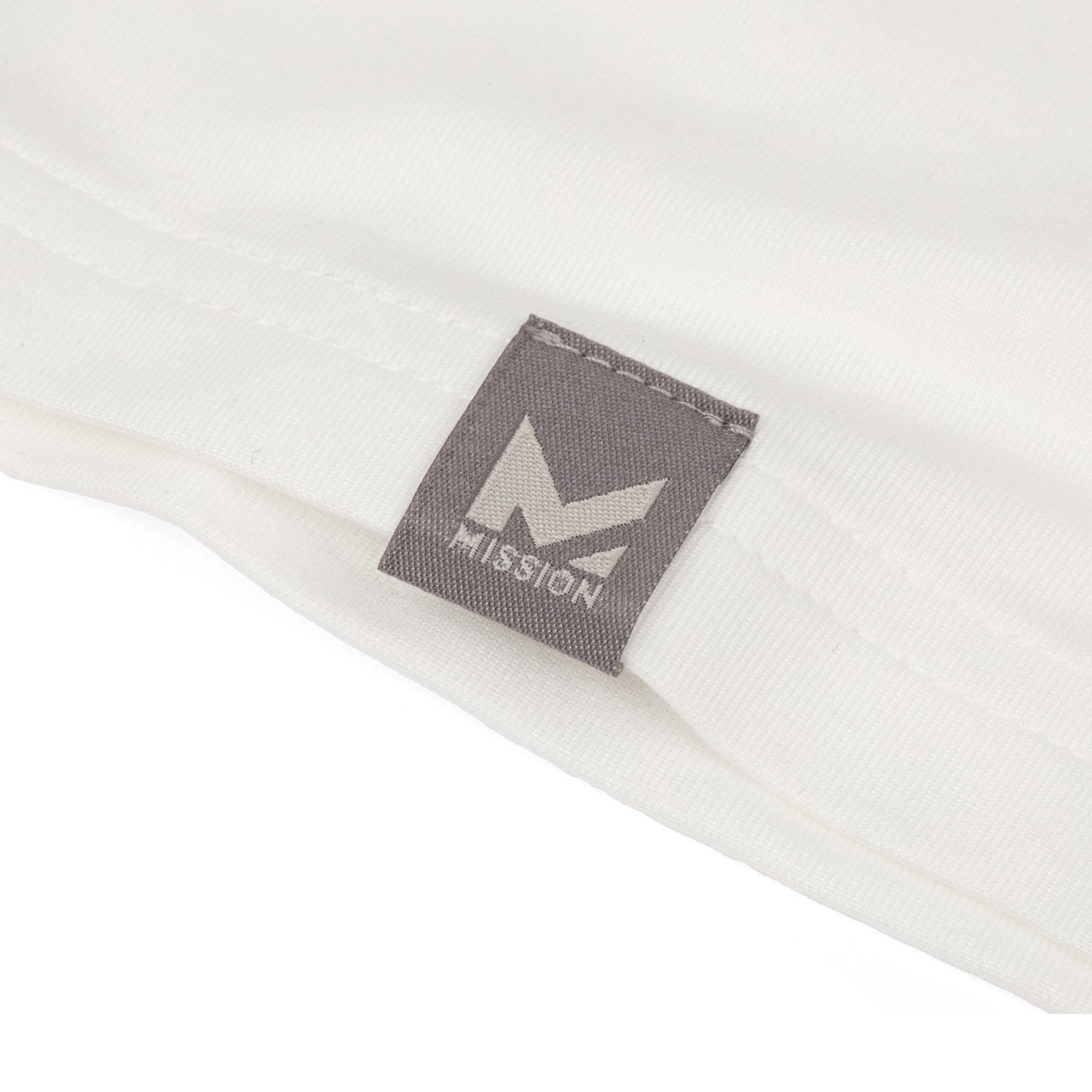 Close-up of a gray tag with 'Mission' logo on a white background