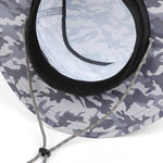Close-up of a camouflage sun hat with a gray and white camo pattern, black mesh ventilation lining, and a silver drawstring.