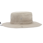 A light beige wide-brimmed bucket hat with a small silver metal emblem on the front, shown against a plain white background.