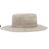 A light beige wide-brimmed bucket hat with a small silver metal emblem on the front, shown against a plain white background.