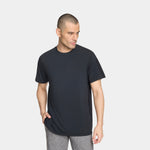 Man wearing a black t-shirt and gray pants on a white background