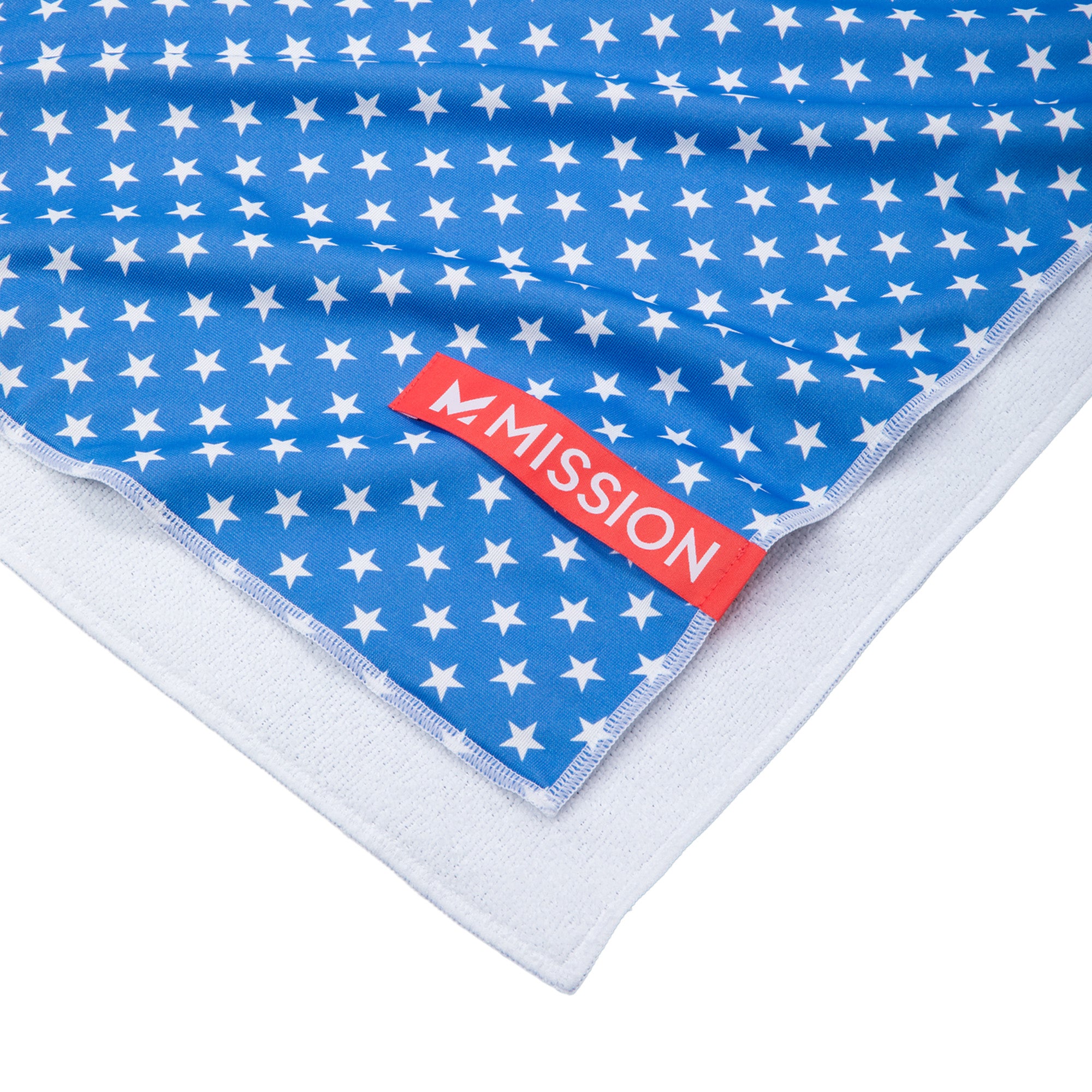 Blue towel with white star pattern and red 'Mission' label on a white background