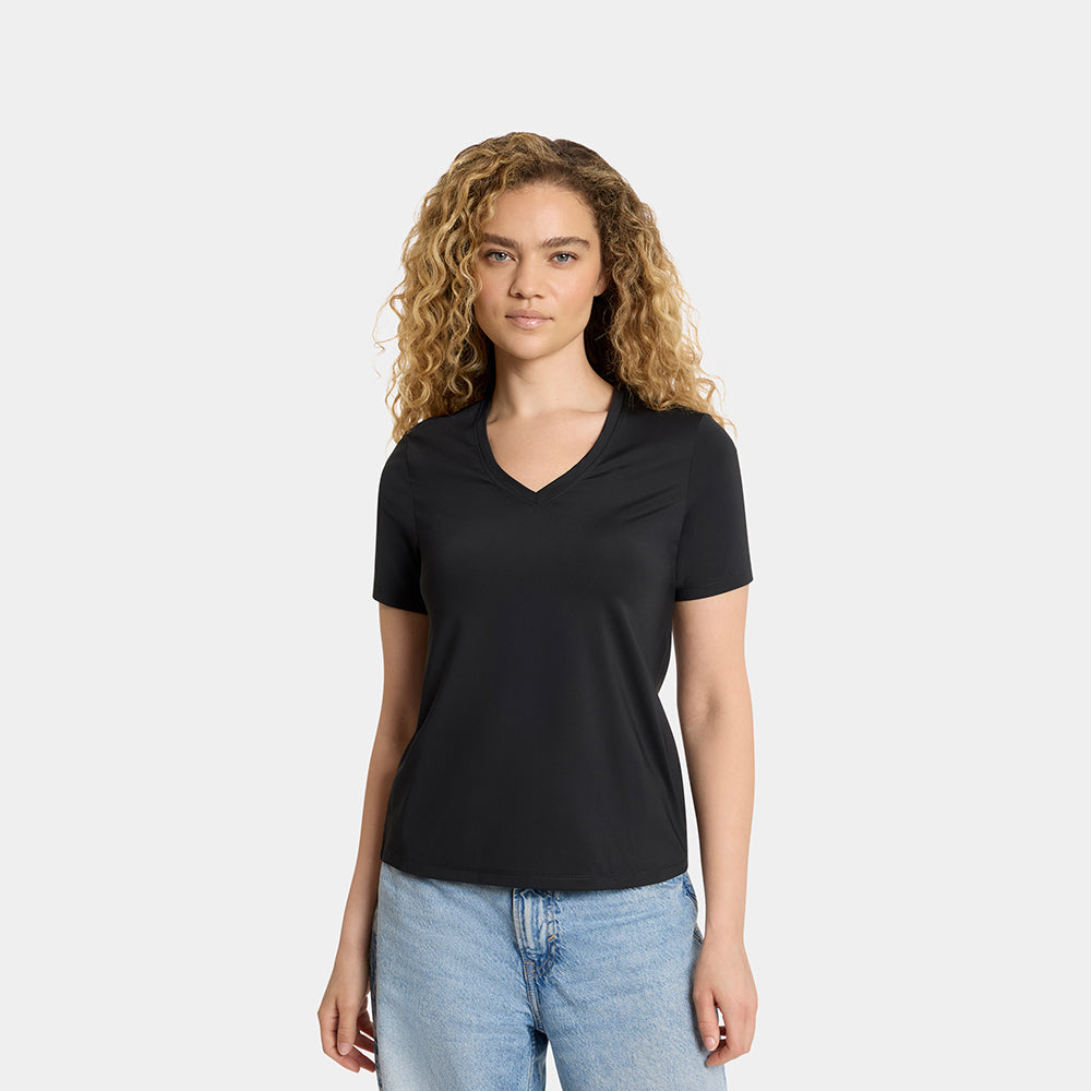 Woman wearing a black t-shirt and blue jeans on a white background